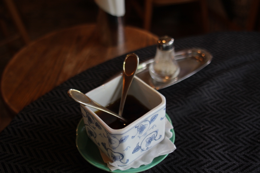036D8B78-E51B-4800-AE79-F91E688C6539_1_105_c Gravity Worx's specialty: House-made chili oil and signature basil salt served in a traditional ceramic container with spoons — specialty condiments at a long-standing Hakuba pasta café known for its unique flavors and handcrafted seasonings.
