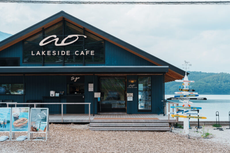 Ao Lakeside Café exterior with wooden deck and lake view in Hakuba, Nagano, Japan