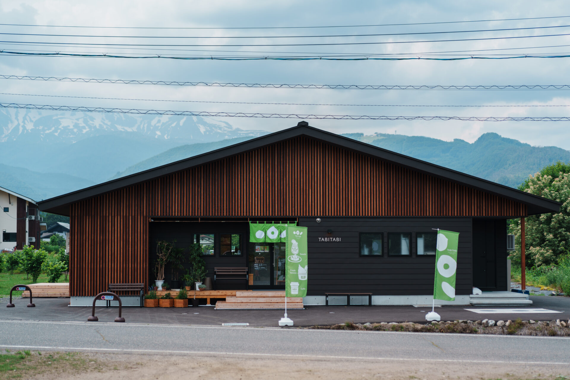 Exterior view of TABITABI Café in Hakuba, Nagano – modern wooden architecture set against the Japanese Alps, offering sustainable gelato and sweets