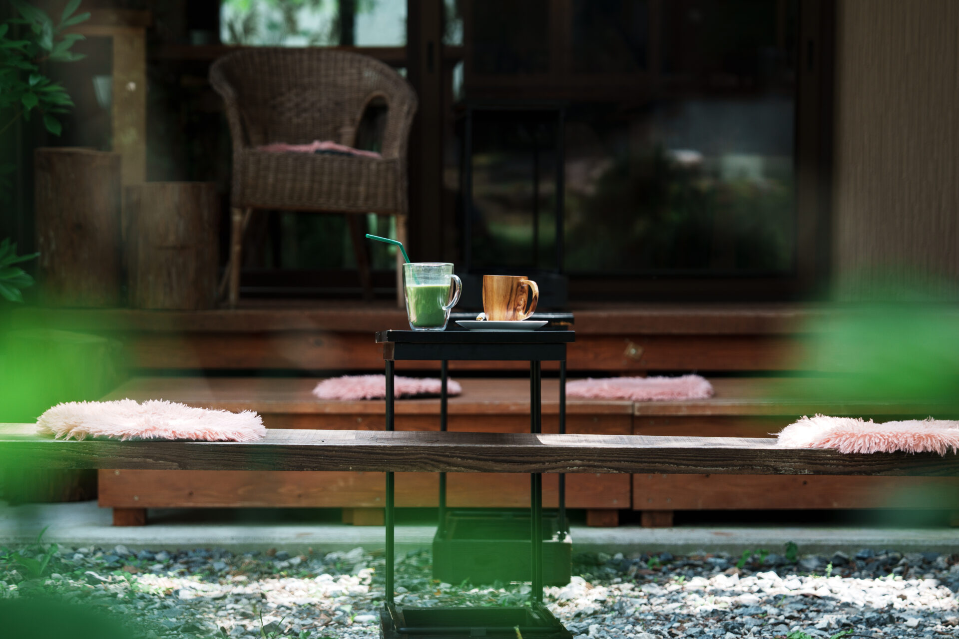 Outdoor seating area at Hakuba café with matcha latte and coffee on table