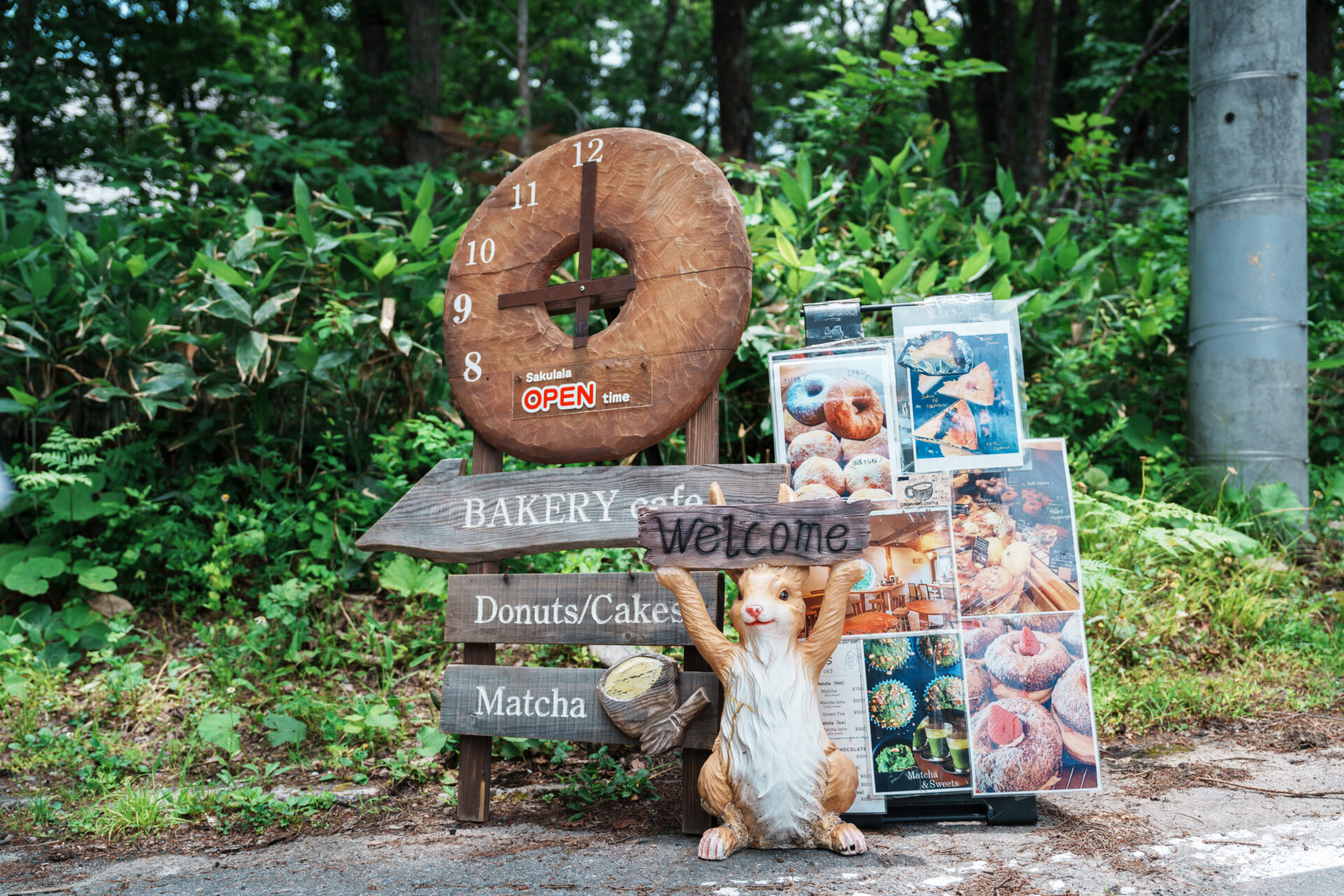 Cute rabbit statue holding up a welcome sign at the café entrance
