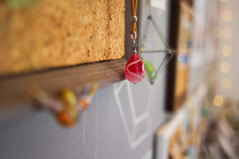 Beautiful red glass bead shaped like a water droplet on display at Kira Kira Glass.