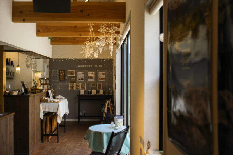 Interior of Kira Kira Glass studio in Hakuba, Nagano, featuring warm wooden beams, handmade glass decorations, and a cozy workshop area with natural light and mountain views.