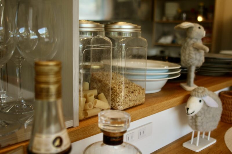 Gravity Worx's specialty: House-made chili oil and signature basil salt served in a traditional ceramic container with spoons — specialty condiments at a long-standing Hakuba pasta café known for its unique flavors and handcrafted seasonings.