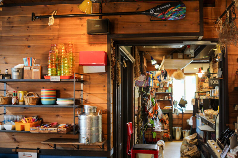 Eclectic interior of Sounds Like Café Hakuba with colorful glassware, wooden walls, and playful décor creating a lively atmosphere.