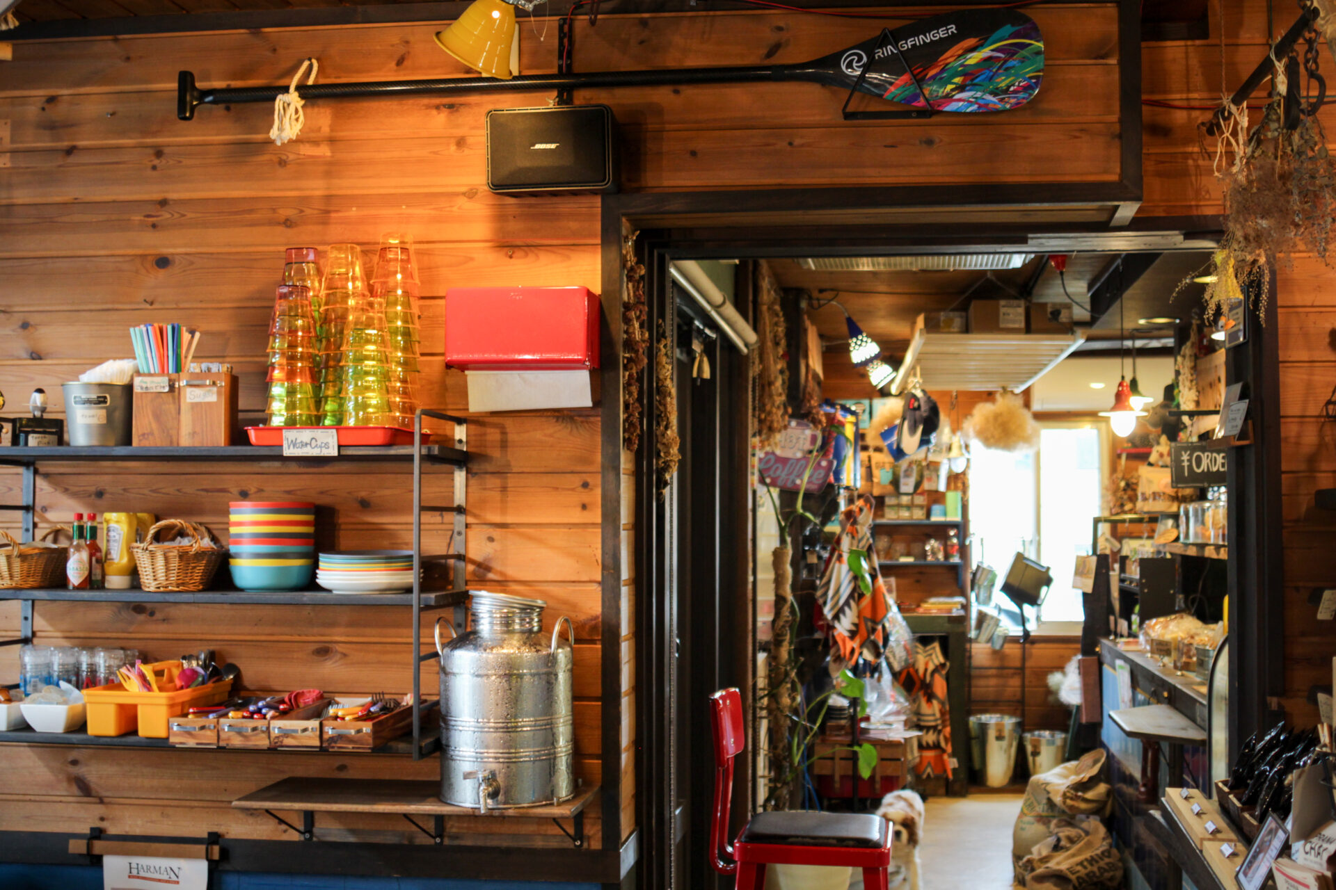 IMG_2743 2 Eclectic interior of Sounds Like Café Hakuba with colorful glassware, wooden walls, and playful décor creating a lively atmosphere.