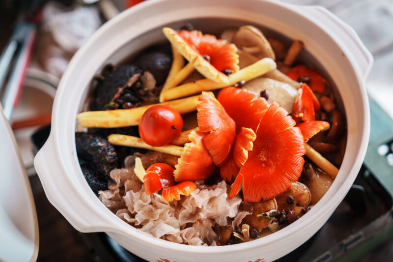 Cooking colourful mushrooms in a Nabe pot.