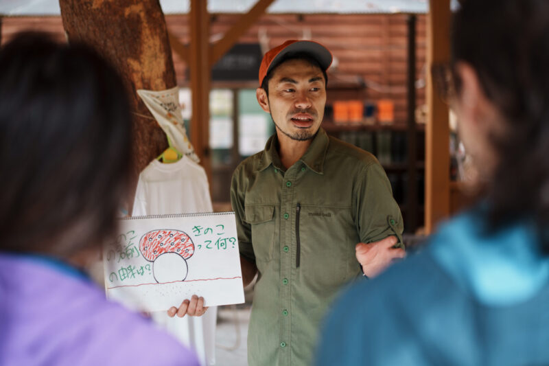 Guide explaining mushroom picking at Otari Nature School in Nagano