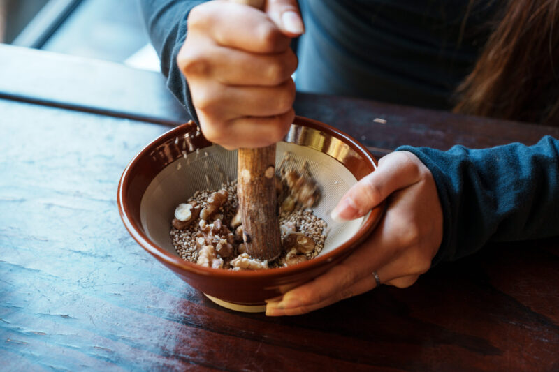 DSC07806 Hand holding a CHAVATY HAKUBA iced matcha latte with mountain views in the background — premium tea latte specialty café in the Japanese Alps, offering scenic outdoor experiences and artisanal drinks made with carefully selected tea leaves.