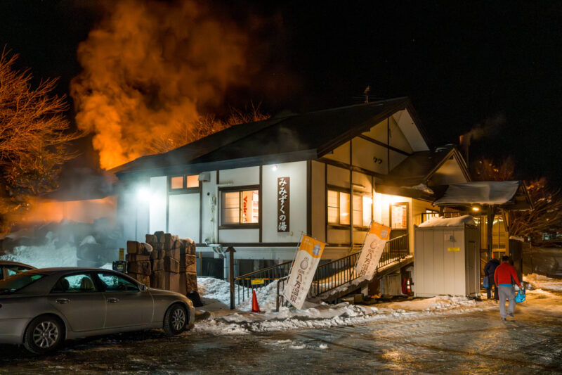 Interior of Kira Kira Glass studio in Hakuba, Nagano, featuring warm wooden beams, handmade glass decorations, and a cozy workshop area with natural light and mountain views.