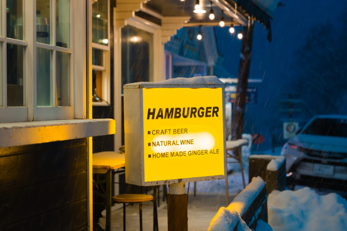 Interior of Kira Kira Glass studio in Hakuba, Nagano, featuring warm wooden beams, handmade glass decorations, and a cozy workshop area with natural light and mountain views.